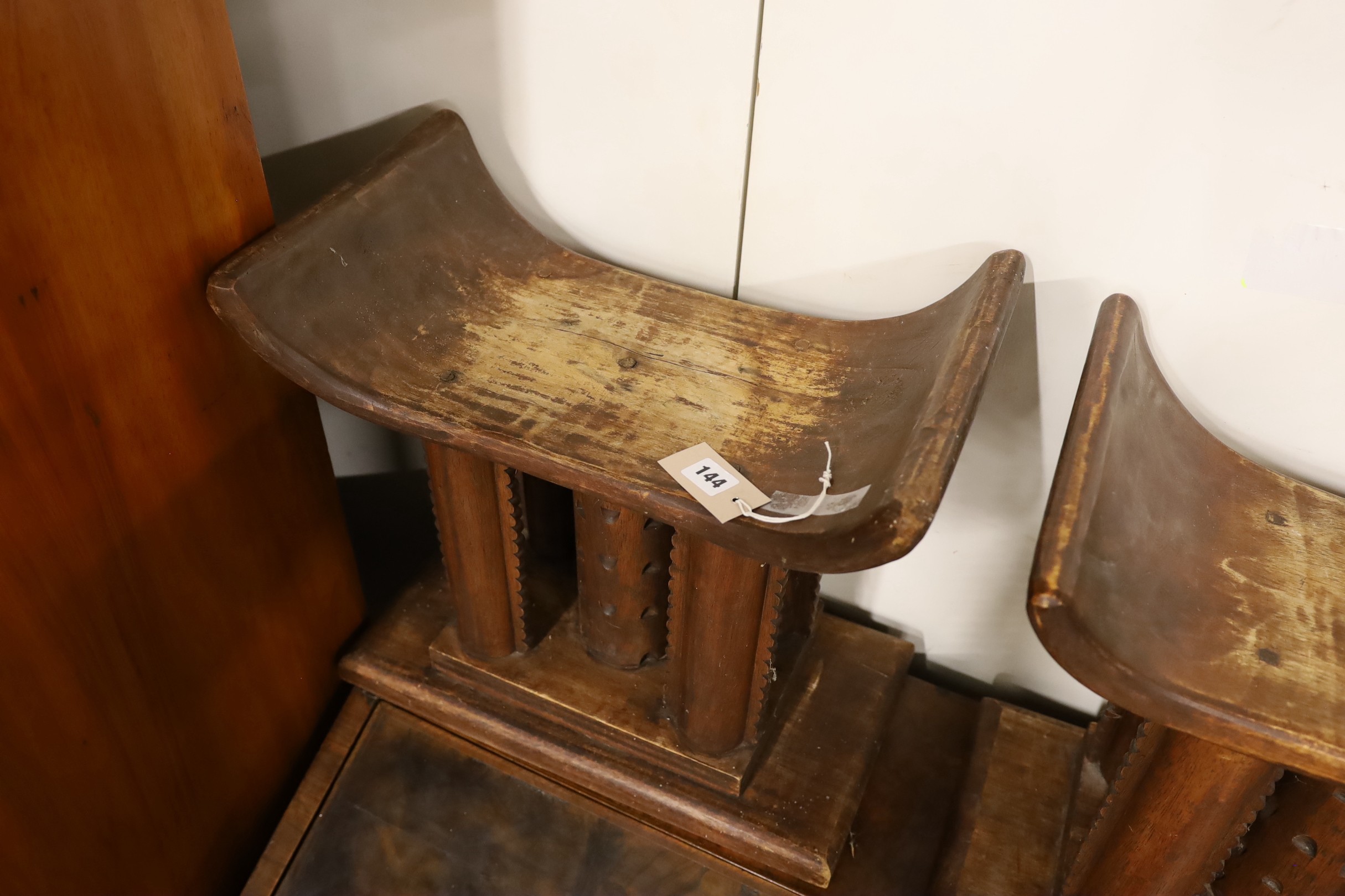 A pair of African carved hardwood stools, width 46cm, depth 29cm, height 43cm